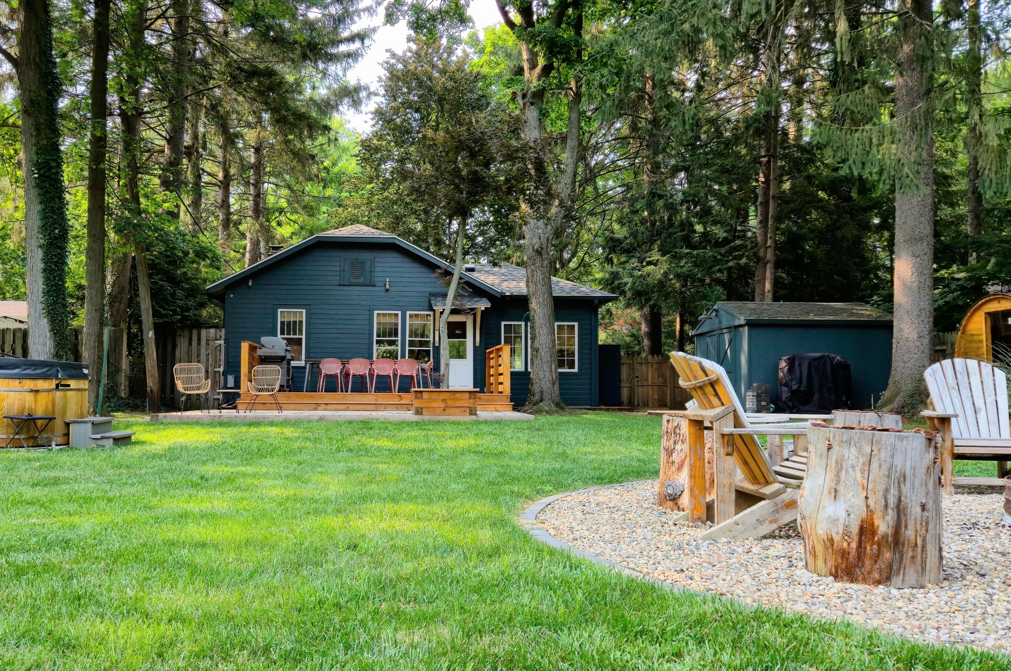 Wide view of the backyard with hot tub and sauna