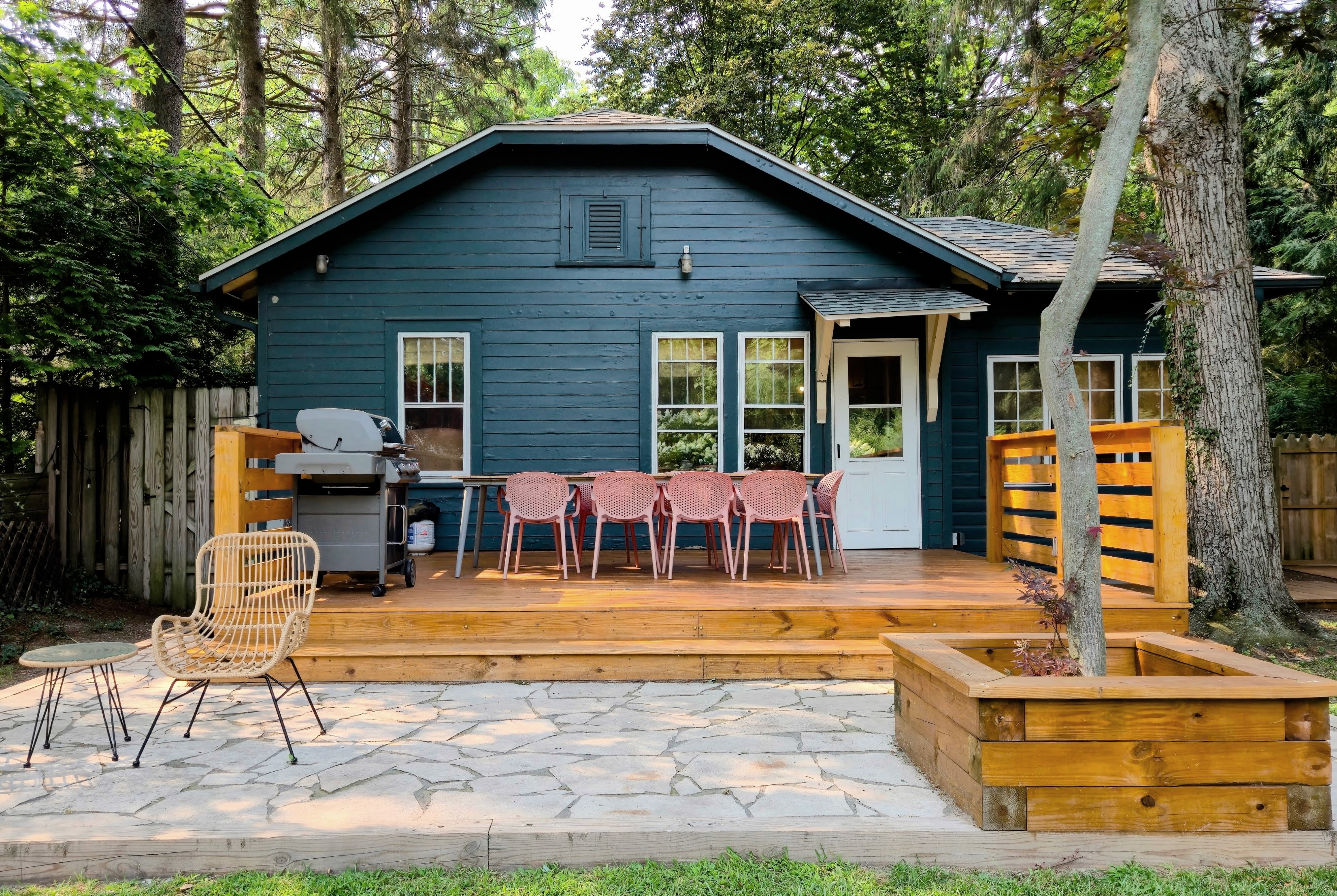 Backyard patio with string lights and grill in the evening